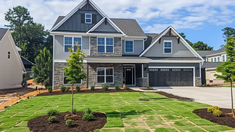 New construction home in Raleigh NC subdivision with fresh sod and young landscaping