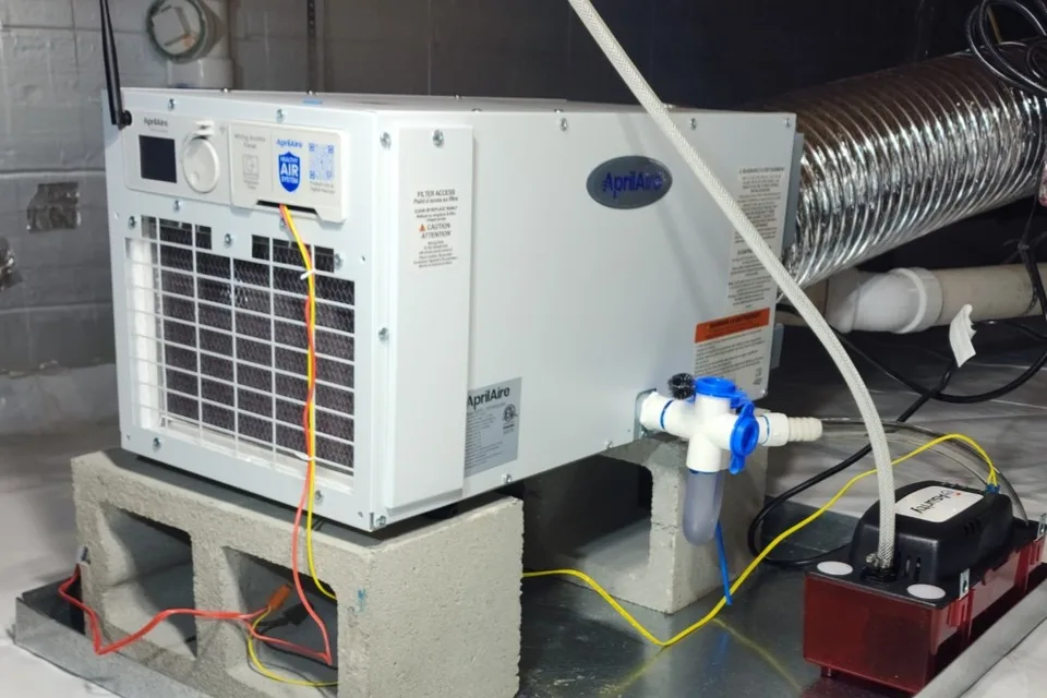 AprilAire dehumidifier mounted on blocks with condensate pump in an encapsulated crawl space in Raleigh NC