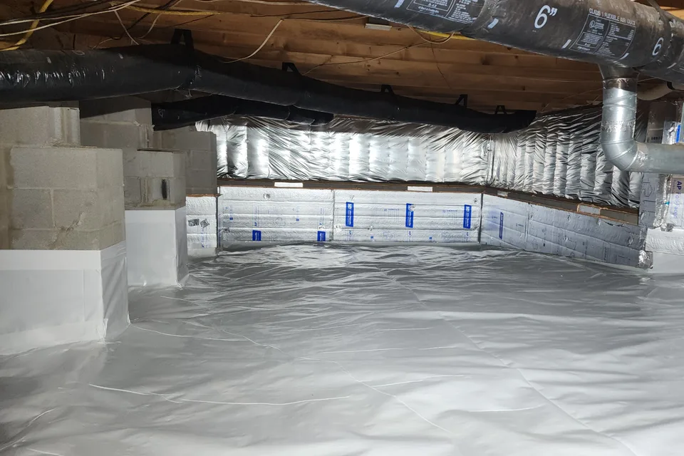 Encapsulated crawl space with vapor barrier on the floor and foundation walls in Raleigh NC